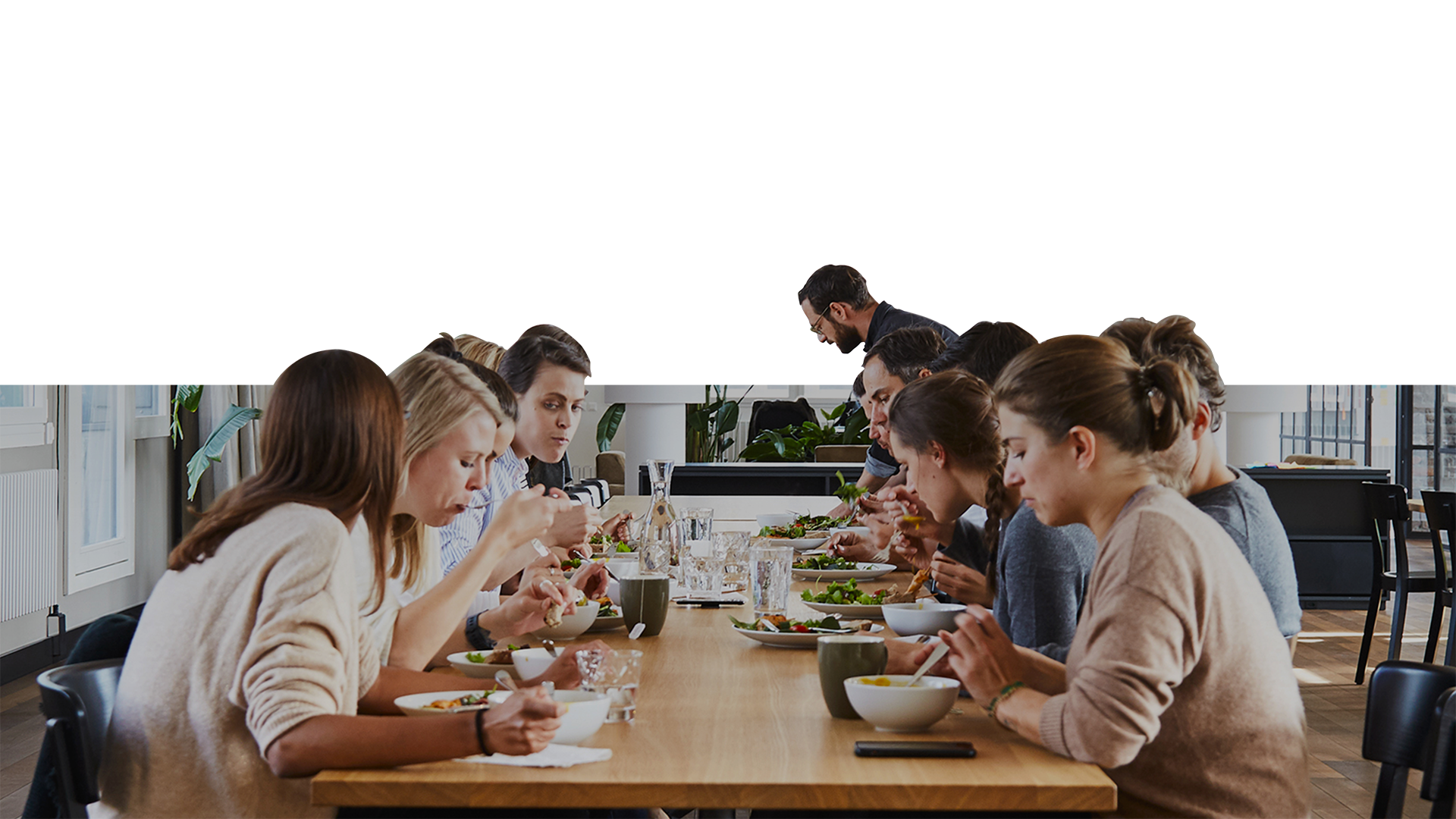 A group of people sitting around a table eating food.