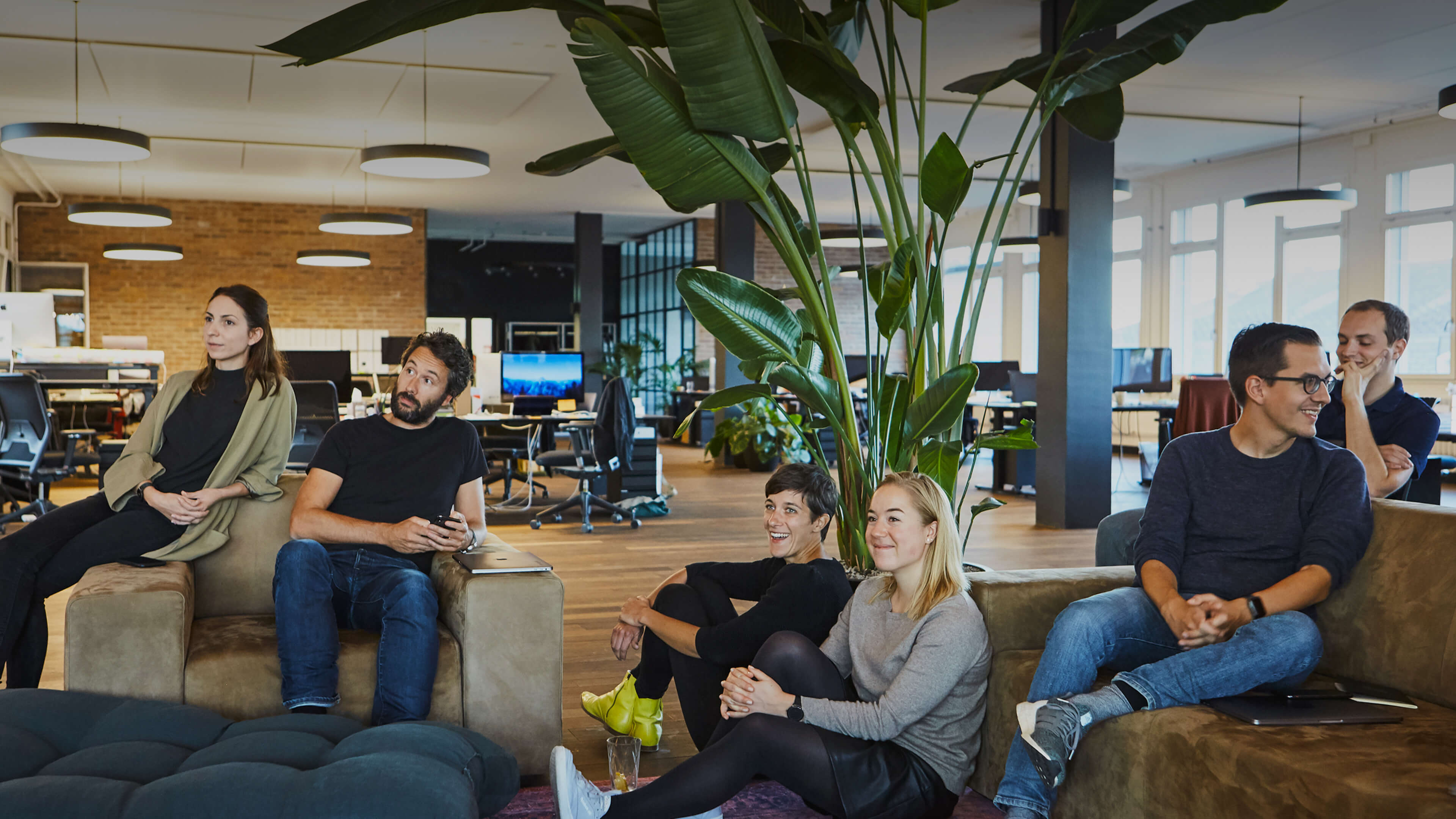 A group of people sitting on couches in a room.