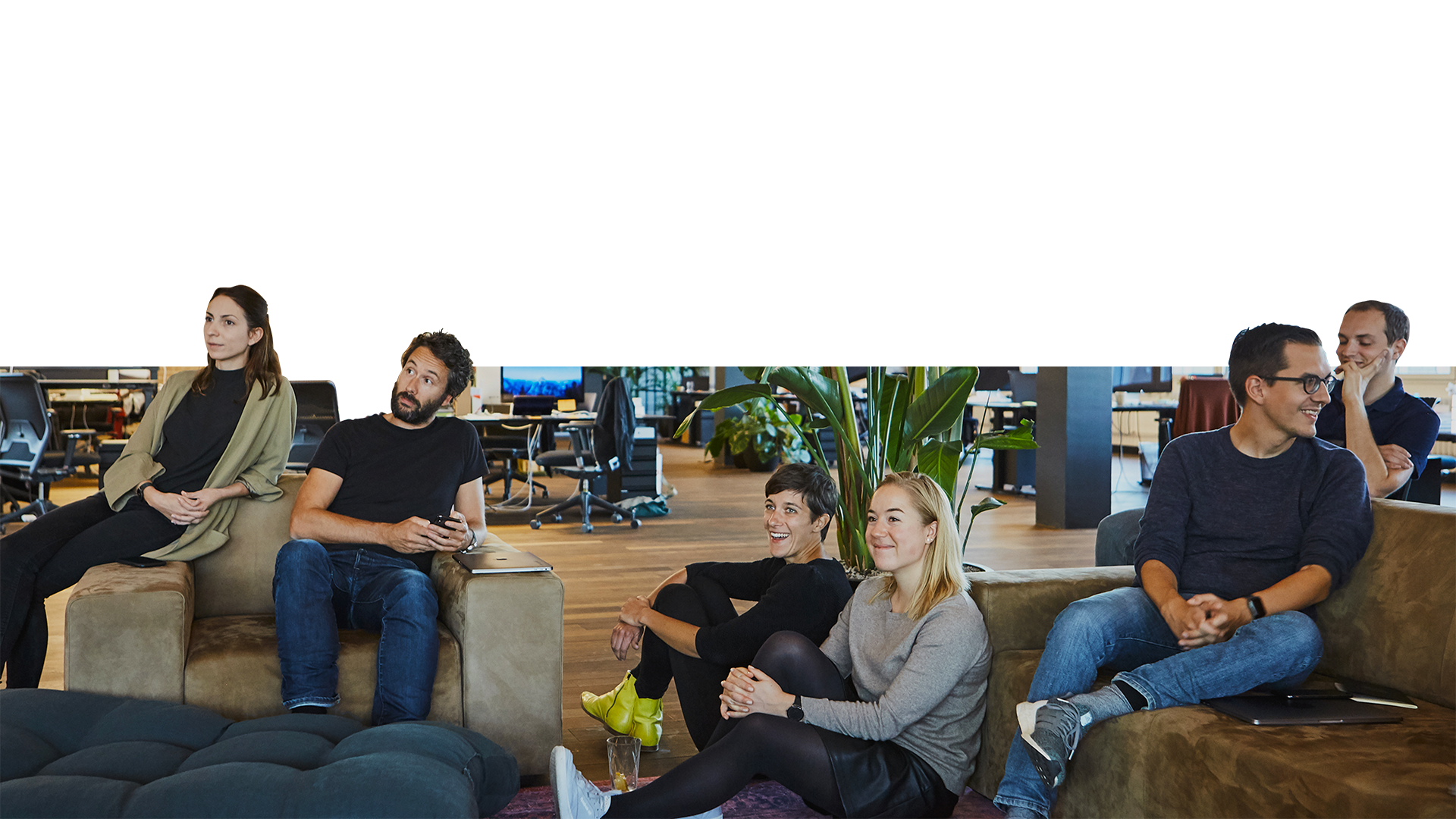 A group of people sitting on couches in a living room.