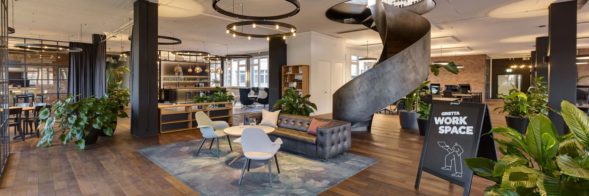 A living room filled with furniture and a spiral staircase.